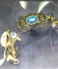Dije acero dorado delfines y figura con piedra turquesa